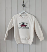 Christmas Jumper with red vintage car embroidered on the front, arrying Christmas tree